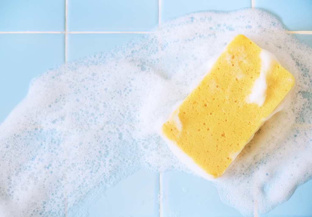 foaming sponge on blue tiles