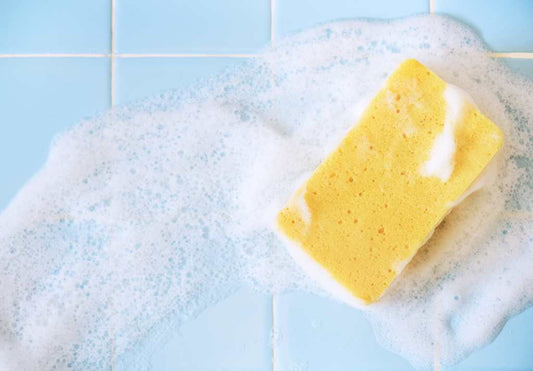 foaming sponge on blue tiles
